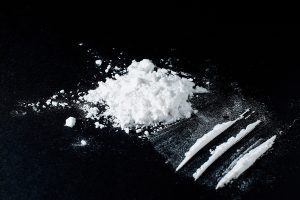 Heroin divided into paths on a black background